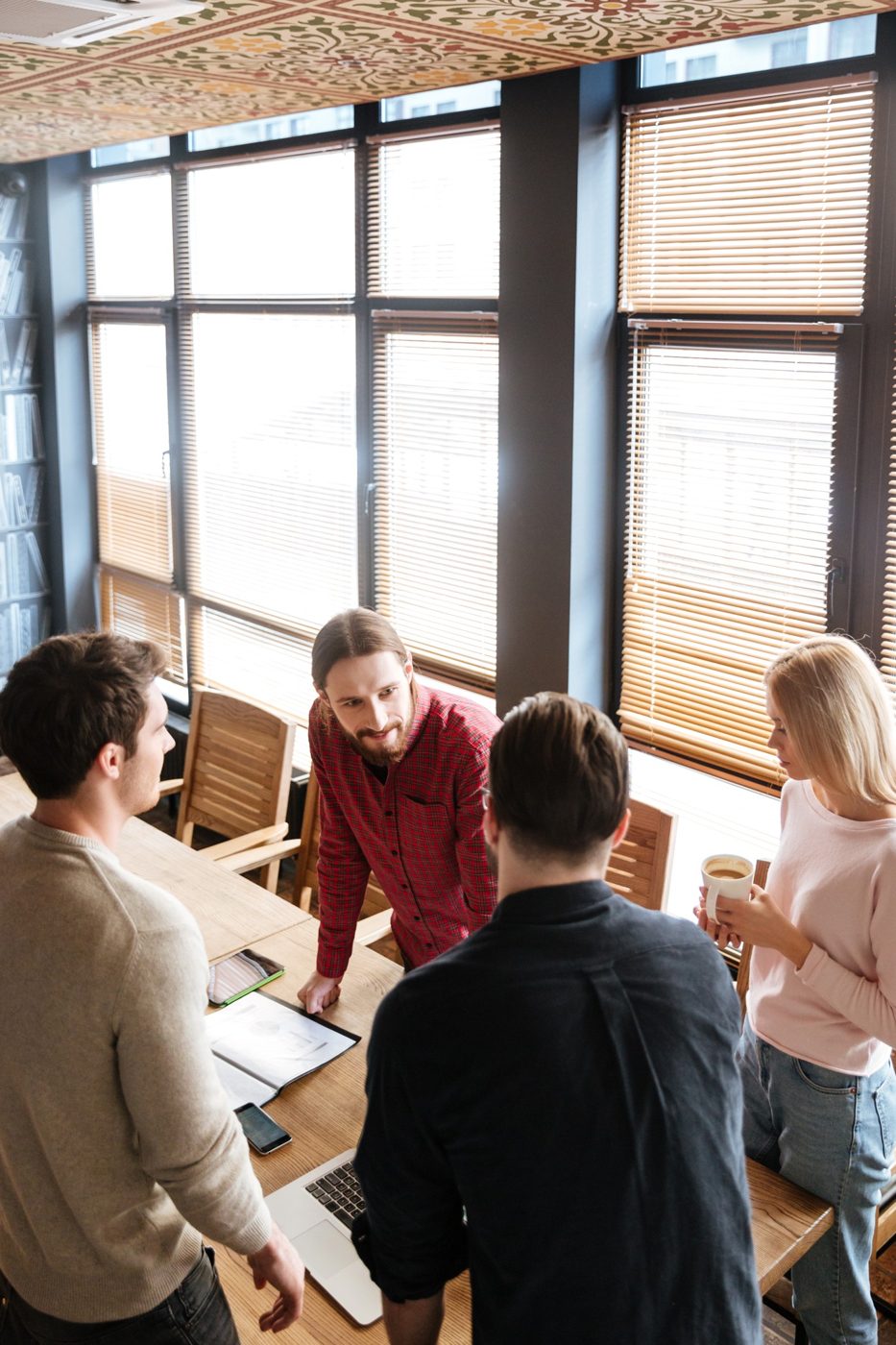 A team talking around a table by the window